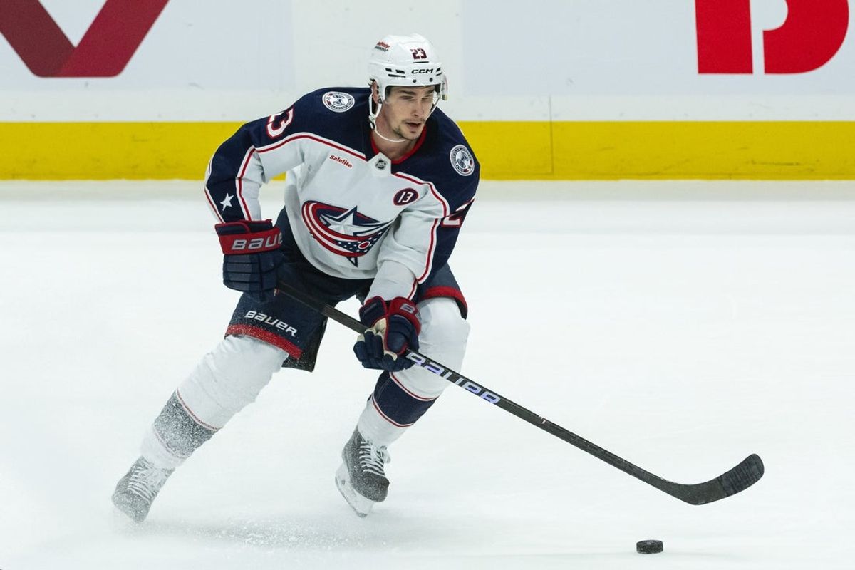 Mar 29, 2025; Ottawa, Ontario, CAN; Columbus Blue Jackets center Sean Monahan (23) controls  the puck in the third period against the Ottawa Senators at the Canadian Tire Centre. Mandatory Credit: Marc DesRosiers-Imagn Images