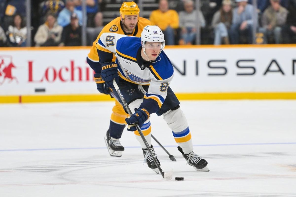 Mar 27, 2025; Nashville, Tennessee, USA;  St. Louis Blues center Dylan Holloway (81) skates with the puck against the Nashville Predators during the second period at Bridgestone Arena. Mandatory Credit: Steve Roberts-Imagn Images