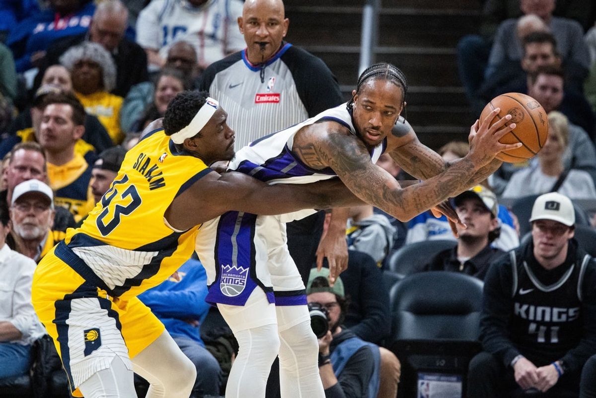 Mar 31, 2025; Indianapolis, Indiana, USA; Sacramento Kings forward DeMar DeRozan (10) holds the ball while Indiana Pacers forward Pascal Siakam (43) defends in the first half at Gainbridge Fieldhouse. Mandatory Credit: Trevor Ruszkowski-Imagn Images