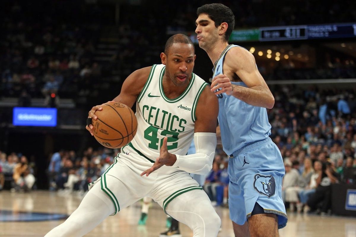 Mar 31, 2025; Memphis, Tennessee, USA; Boston Celtics center Al Horford (42) drives to the basket as Memphis Grizzlies forward Santi Aldama (7) defends during the first quarter at FedExForum. Mandatory Credit: Petre Thomas-Imagn Images