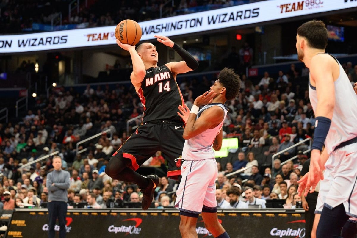 Mar 31, 2025; Washington, District of Columbia, USA; Miami Heat guard Tyler Herro (14) drives to the basket Washington Wizards guard AJ Johnson (5) during the first quarter at Capital One Arena. Mandatory Credit: Reggie Hildred-Imagn Images