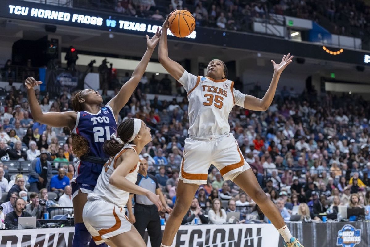 Mar 31, 2025; Birmingham, AL, USA; Texas Longhorns forward Madison Booker (35) rebounds the ball over TCU Horned Frogs guard Agnes Emma-Nnopu (21) during the second half of an Elite 8 NCAA Tournament basketball game at Legacy Arena. Mandatory Credit: Vasha Hunt-Imagn Images
