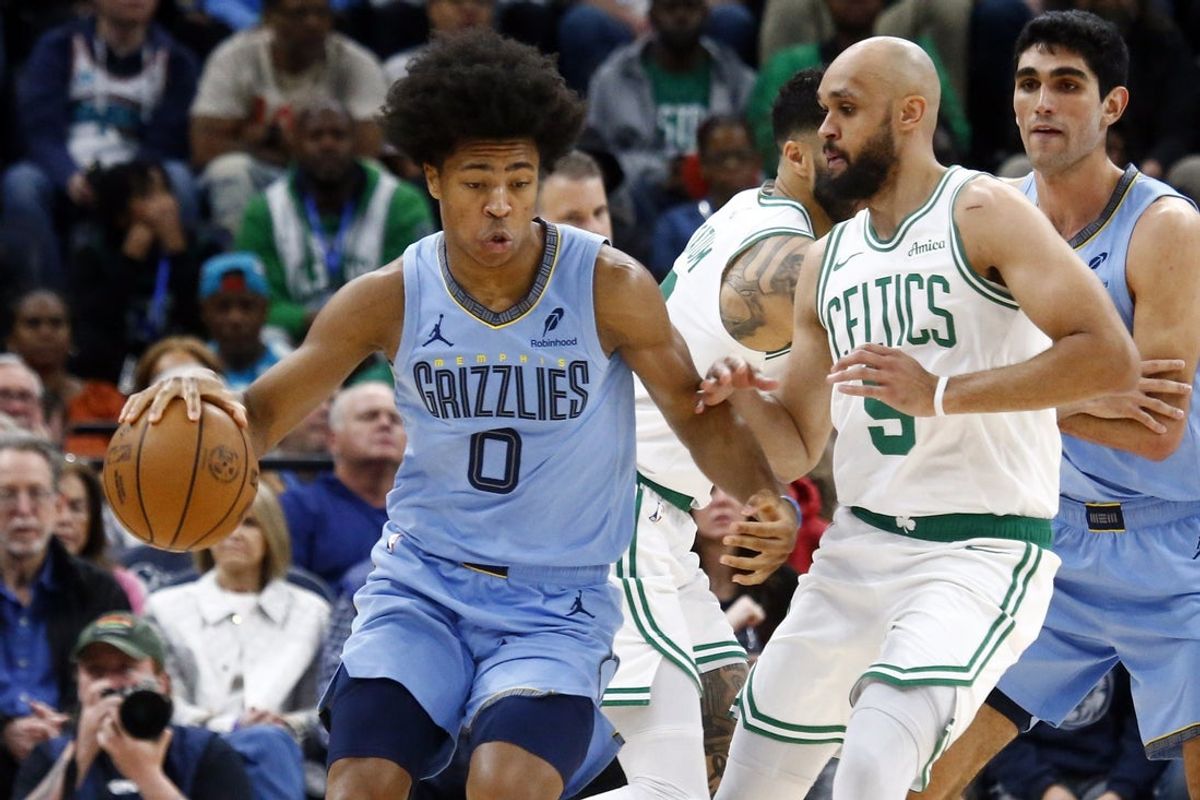 Mar 31, 2025; Memphis, Tennessee, USA; Memphis Grizzlies forward Jaylen Wells (0) dribbles as Boston Celtics guard Derrick White (9) defends during the second quarter at FedExForum. Mandatory Credit: Petre Thomas-Imagn Images