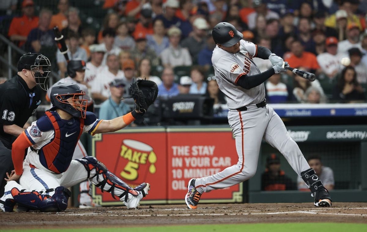Mar 31, 2025; Houston, Texas, USA;  San Francisco Giants designated hitter Wilmer Flores (41) hits a RBI single against the Houston Astros in the second inning at Daikin Park. Mandatory Credit: Thomas Shea-Imagn Images