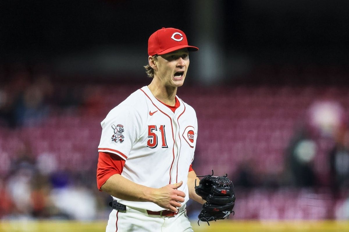 Mar 31, 2025; Cincinnati, Ohio, USA; Cincinnati Reds starting pitcher Brady Singer (51) reacts after a play in the sixth inning against the Texas Rangers at Great American Ball Park. Mandatory Credit: Katie Stratman-Imagn Images