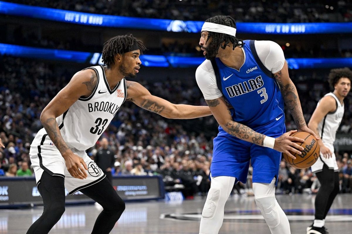 Mar 31, 2025; Dallas, Texas, USA; Dallas Mavericks forward Anthony Davis (3) looks to move the ball past Brooklyn Nets center Nic Claxton (33) during the second quarter at the American Airlines Center. Mandatory Credit: Jerome Miron-Imagn Images