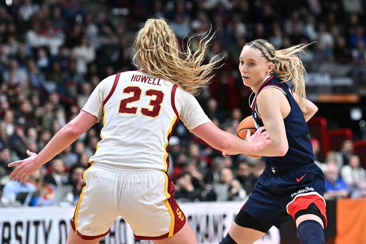 Mar 31, 2025; Spokane, WA, USA; UConn Huskies guard Paige Bueckers (5) controls the ball against USC Trojans guard Avery Howell (23) during the second half of a Elite 8 NCAA Tournament basketball game at Spokane Arena. Mandatory Credit: James Snook-Imagn Images