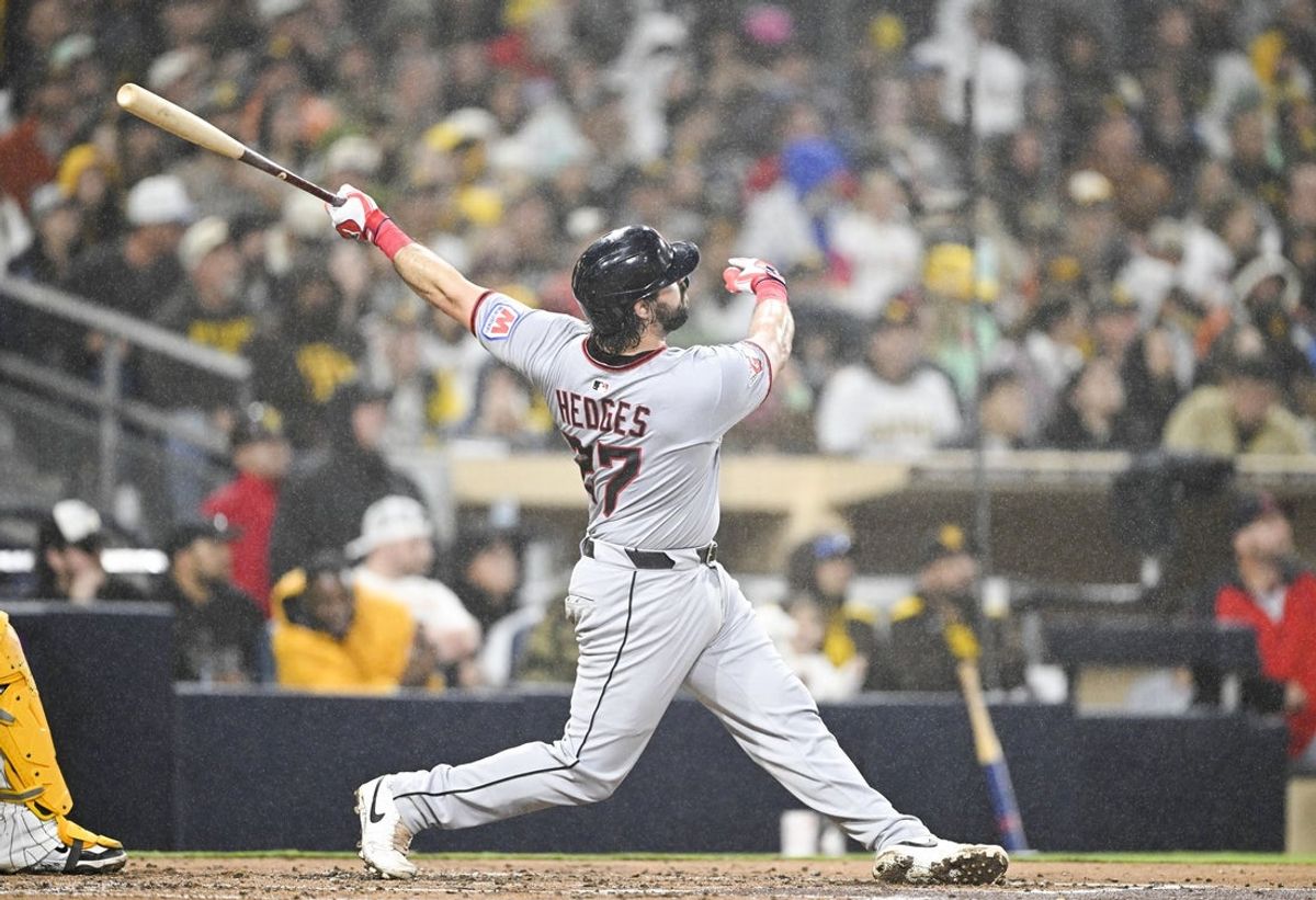 Mar 31, 2025; San Diego, California, USA; Cleveland Guardians catcher Austin Hedges (27) hits a solo home run during the second inning against the San Diego Padres at Petco Park. Mandatory Credit: Denis Poroy-Imagn Images
