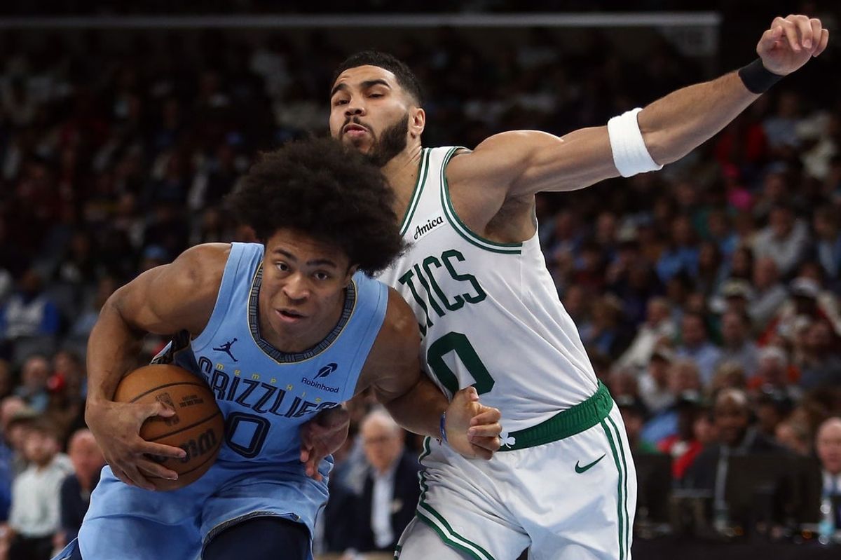 Mar 31, 2025; Memphis, Tennessee, USA; Memphis Grizzlies forward Jaylen Wells (0) drives to the basket as Boston Celtics forward Jayson Tatum (0) defends during the third quarter at FedExForum. Mandatory Credit: Petre Thomas-Imagn Images