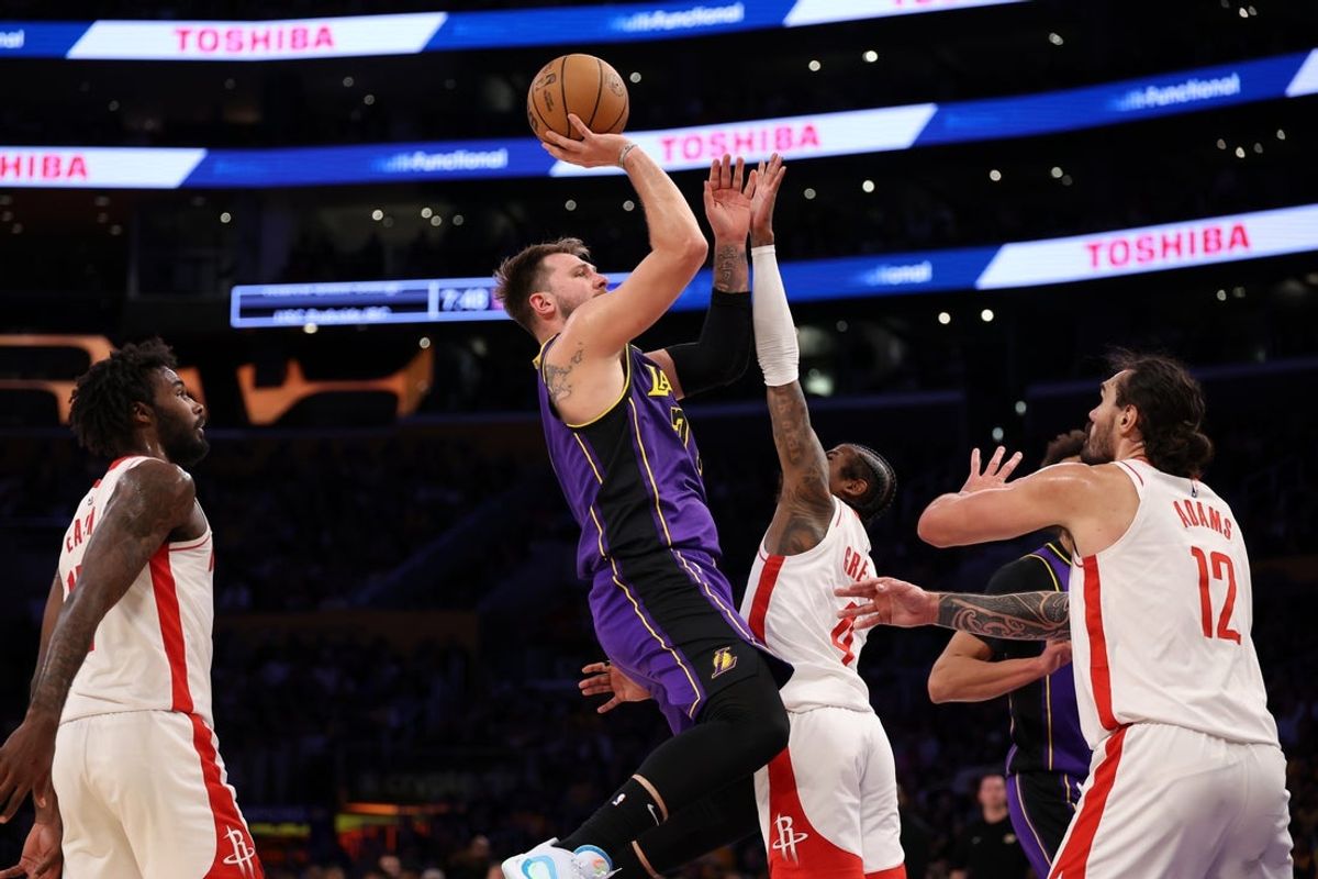 Mar 31, 2025; Los Angeles, California, USA;  Los Angeles Lakers guard Luka Doncic (77) shoots the ball over Houston Rockets guard Jalen Green (4) during the first half at Crypto.com Arena. Mandatory Credit: Kiyoshi Mio-Imagn Images