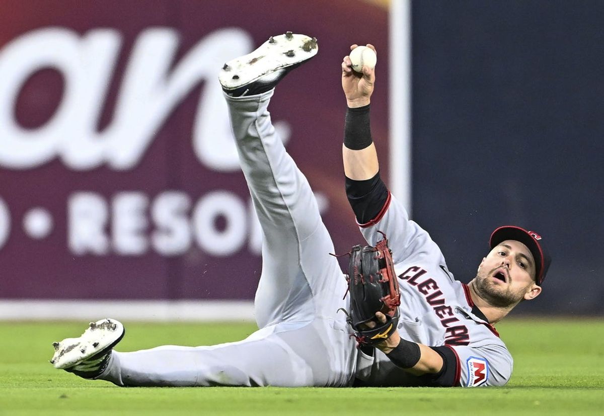 Mar 31, 2025; San Diego, California, USA; Cleveland Guardians outfielder Lane Thomas (8) holds the ball up after making a catch on a ball hit by San Diego Padres second baseman Xander Bogaerts (not pictured) during the third inning at Petco Park. Mandatory Credit: Denis Poroy-Imagn Images