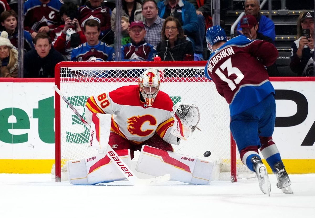 Mar 31, 2025; Denver, Colorado, USA; Calgary Flames goaltender Dan Vladar (80) makes a shoot out save on Colorado Avalanche right wing Valeri Nichushkin (13) at Ball Arena. Mandatory Credit: Ron Chenoy-Imagn Images
