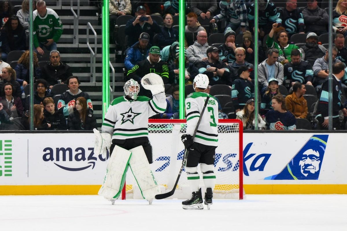 Mar 31, 2025; Seattle, Washington, USA; Dallas Stars goaltender Casey DeSmith (1) and defenseman Mathew Dumba (3) celebrate after defeating the Seattle Kraken at Climate Pledge Arena. Mandatory Credit: Steven Bisig-Imagn Images