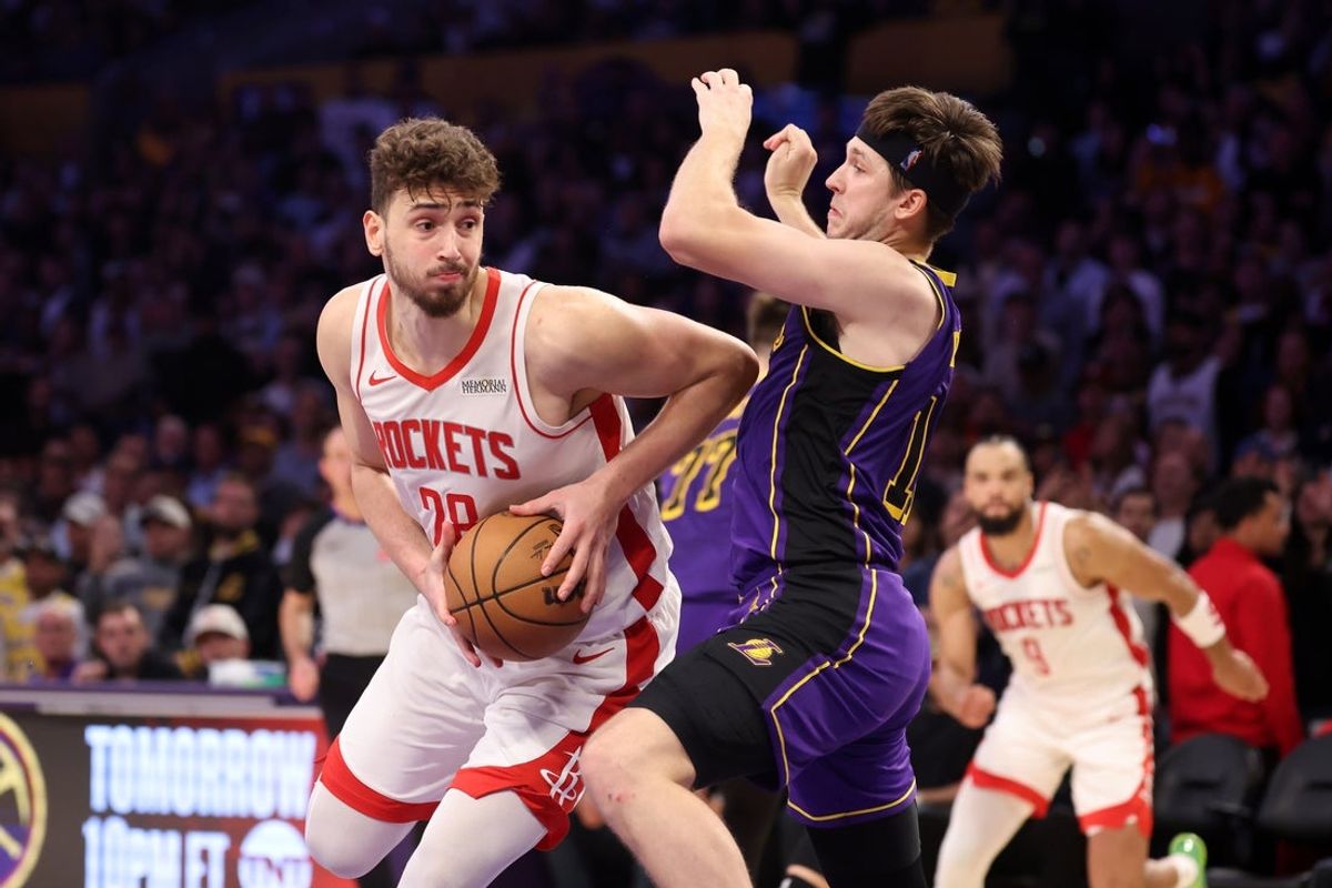 Mar 31, 2025; Los Angeles, California, USA;  Houston Rockets center Alperen Sengun (28) goes to the basket against Los Angeles Lakers guard Austin Reaves (15) during the fourth quarter at Crypto.com Arena. Mandatory Credit: Kiyoshi Mio-Imagn Images