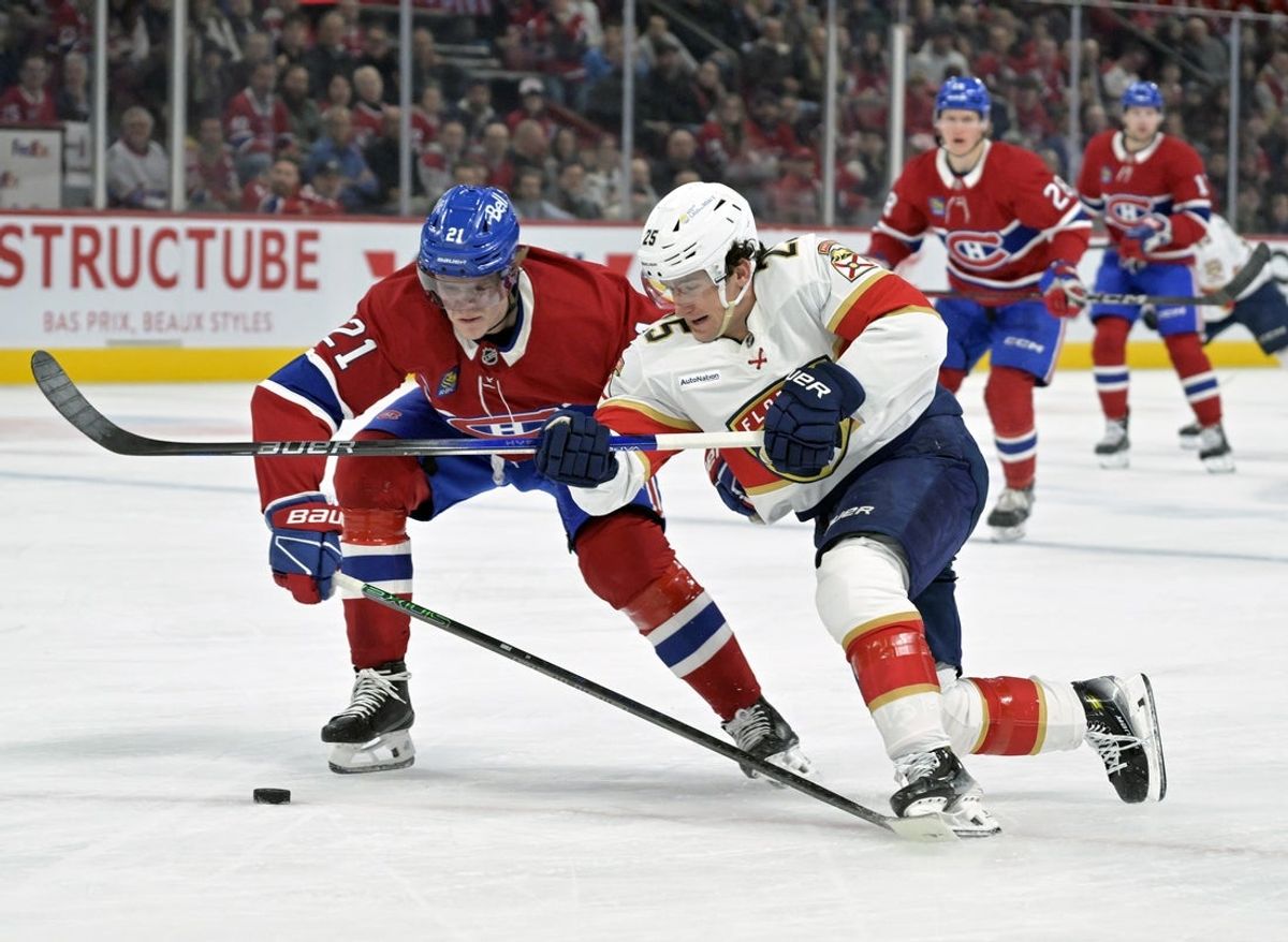 Apr 1, 2025; Montreal, Quebec, CAN; Montreal Canadiens defenseman Kaiden Guhle (21) and Florida Panthers forward Mackie Samoskevich (25) battle for the puck during the first period at the Bell Centre. Mandatory Credit: Eric Bolte-Imagn Images