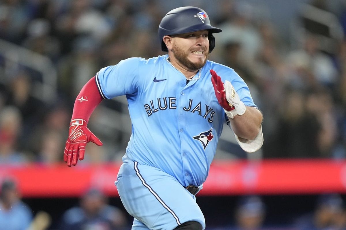 Apr 1, 2025; Toronto, Ontario, CAN;  Toronto Blue Jays catcher Alejandro Kirk (30) runs to first base on a single against the Washington Nationals during the third inning at Rogers Centre. Mandatory Credit: John E. Sokolowski-Imagn Images