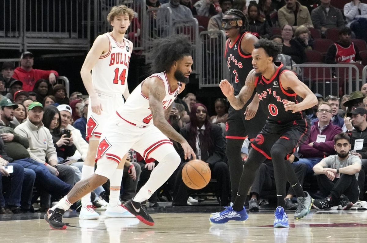 Apr 1, 2025; Chicago, Illinois, USA; Chicago Bulls guard Coby White (0) drives on Toronto Raptors guard A.J. Lawson (0) during the first quarter at United Center. Mandatory Credit: David Banks-Imagn Images