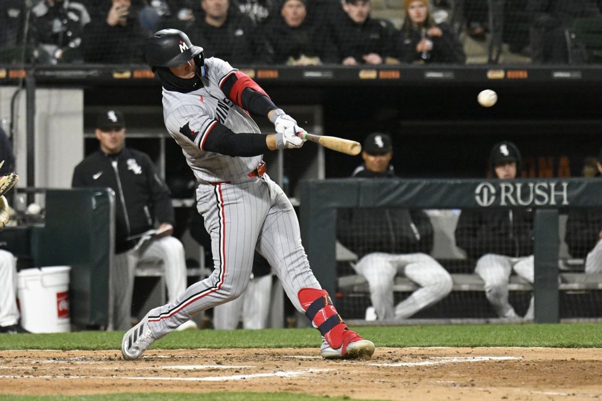 Apr 1, 2025; Chicago, Illinois, USA;  Minnesota Twins first baseman Ty France (13) singles against the Chicago White Sox during the fifth inning at Guaranteed Rate Field. Mandatory Credit: Matt Marton-Imagn Images
