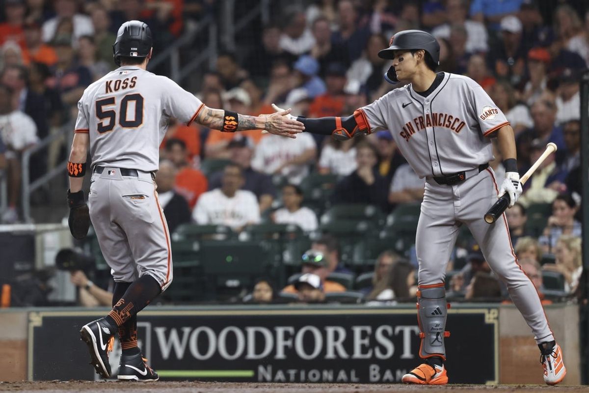 Apr 1, 2025; Houston, Texas, USA; San Francisco Giants second baseman Christian Koss (50) celebrates with center fielder Jung Hoo Lee (51) after scoring a run during the third inning against the Houston Astros at Daikin Park. Mandatory Credit: Troy Taormina-Imagn Images