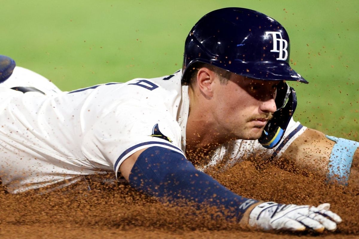 Apr 1, 2025; St. Petersburg, Florida, USA; Tampa Bay Rays center fielder Jonny DeLuca (21) slides into third base after hitting a triple against the Pittsburgh Pirates in the eighth inning at George M. Steinbrenner Field. Mandatory Credit: Nathan Ray Seebeck-Imagn Images