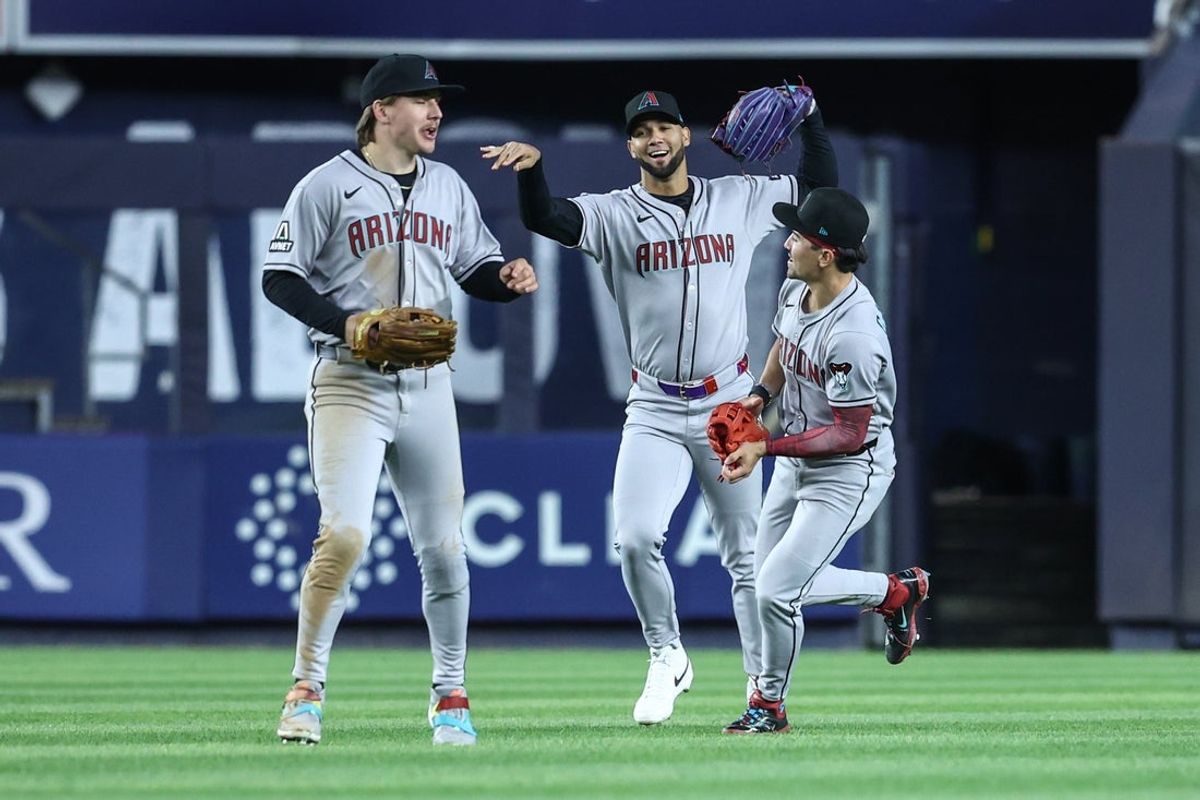 Apr 1, 2025; Bronx, New York, USA;  Arizona Diamondbacks outffielders Jake McCarthy (31), Lourdes Gurriel Jr. (12) and Corbin Carroll (7) celebrate after defeating the New York Yankees at Yankee Stadium. Mandatory Credit: Wendell Cruz-Imagn Images
