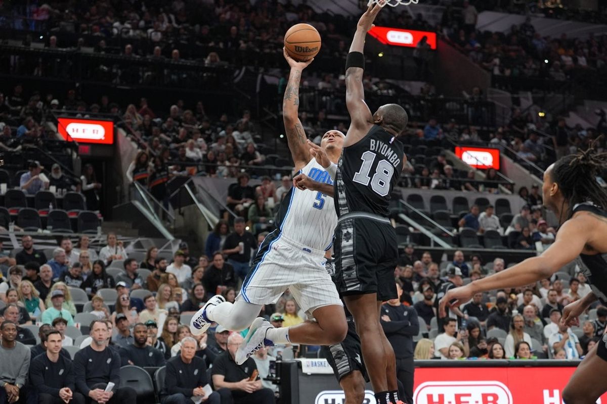 Apr 1, 2025; San Antonio, Texas, USA;  Orlando Magic forward Paolo Banchero (5) goes up for a shot against San Antonio Spurs center Bismack Biyombo (18) in the second half at Frost Bank Center. Mandatory Credit: Daniel Dunn-Imagn Images
