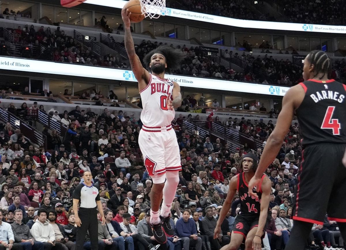 Apr 1, 2025; Chicago, Illinois, USA; Chicago Bulls guard Coby White (0) shoots the ball on Toronto Raptors forward Scottie Barnes (4) during the second half at United Center. Mandatory Credit: David Banks-Imagn Images