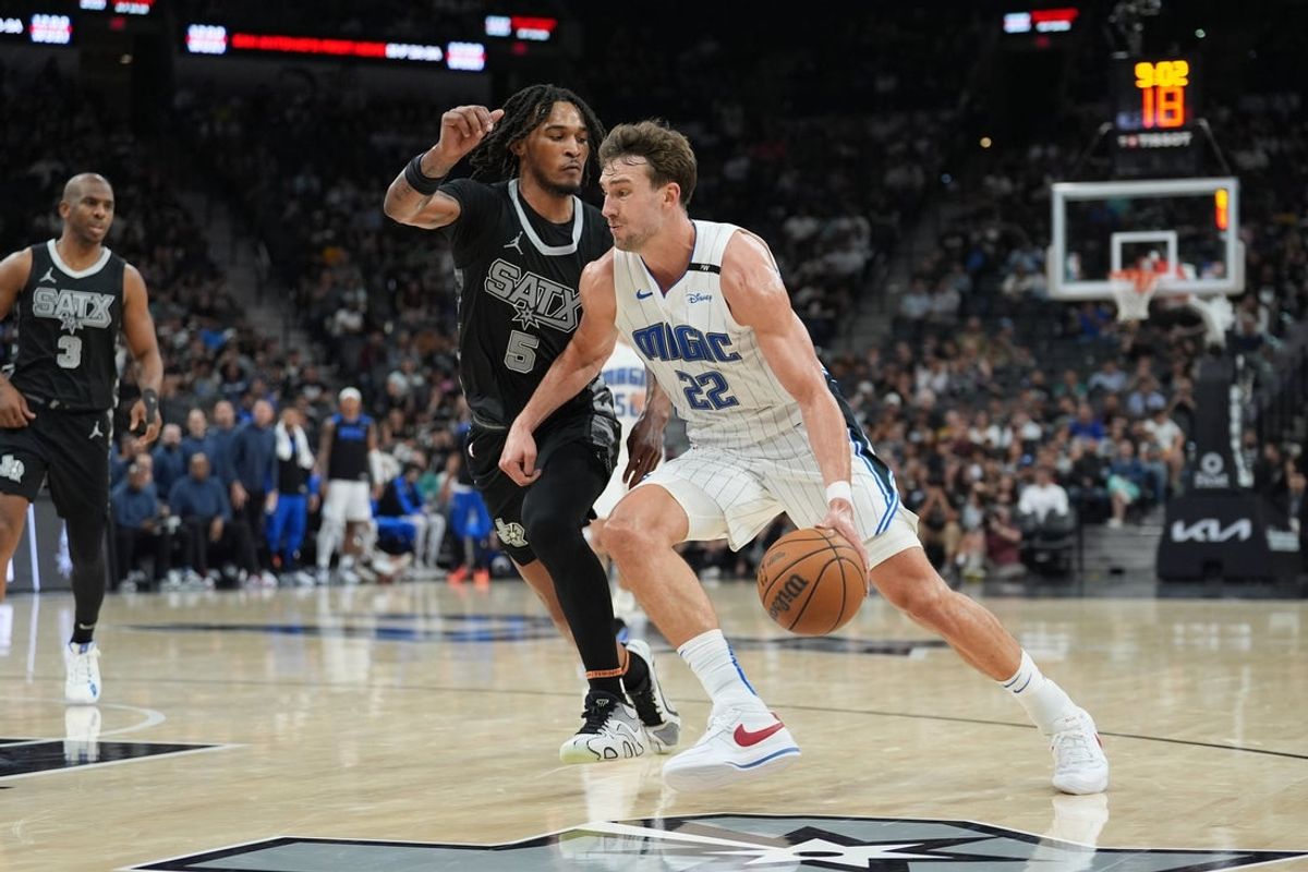 Apr 1, 2025; San Antonio, Texas, USA;  Orlando Magic forward Franz Wagner (22) dribbles against San Antonio Spurs guard Stephon Castle (5) in the second half at Frost Bank Center. Mandatory Credit: Daniel Dunn-Imagn Images