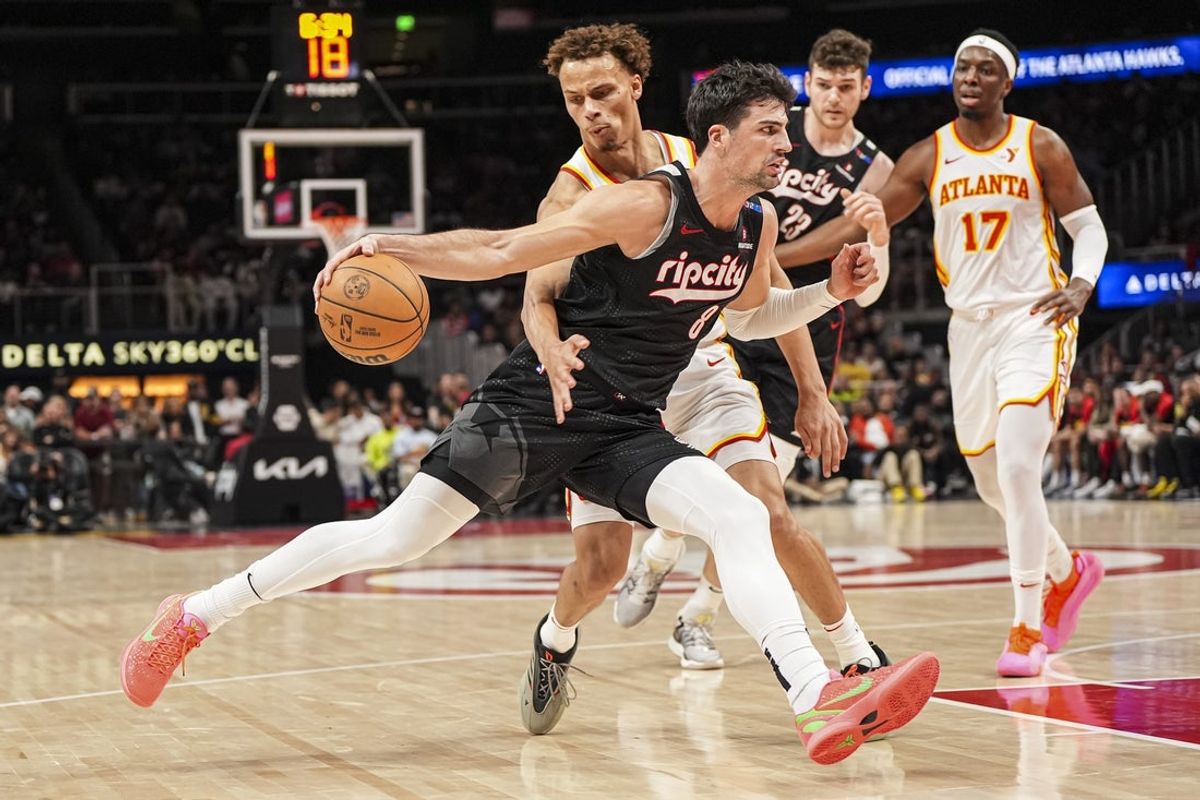 Apr 1, 2025; Atlanta, Georgia, USA; Portland Trail Blazers forward Deni Avdija (8) dribbles defended by Atlanta Hawks guard Dyson Daniels (5) during the second half at State Farm Arena. Mandatory Credit: Dale Zanine-Imagn Images