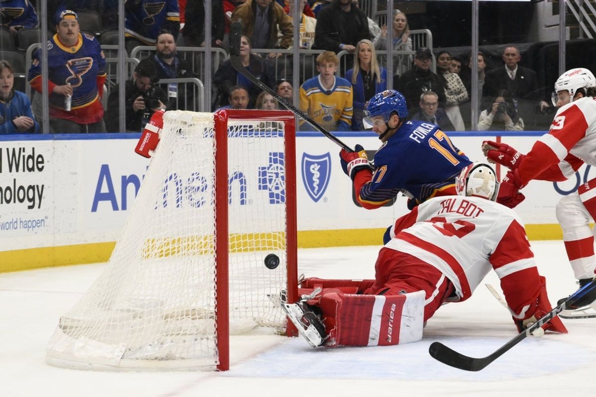 Apr 1, 2025; St. Louis, Missouri, USA; St. Louis Blues defenseman Cam Fowler (17) scores a goal against Detroit Red Wings goaltender Cam Talbot (39) during the overtime at Enterprise Center. Mandatory Credit: Jeff Le-Imagn Images