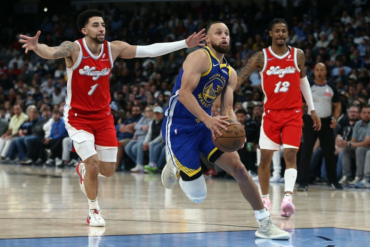 Apr 1, 2025; Memphis, Tennessee, USA; Golden State Warriors guard Stephen Curry (30) drives to the basket between Memphis Grizzlies guard Scotty Pippen Jr. (1) and guard Ja Morant (12) during the fourth quarter at FedExForum. Mandatory Credit: Petre Thomas-Imagn Images