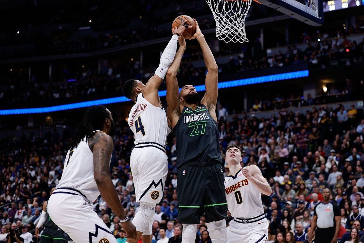 Apr 1, 2025; Denver, Colorado, USA; Denver Nuggets guard Russell Westbrook (4) blocks the shot of Minnesota Timberwolves center Rudy Gobert (27) as center DeAndre Jordan (6) and guard Christian Braun (0) defend in the second quarter at Ball Arena. Mandatory Credit: Isaiah J. Downing-Imagn Images