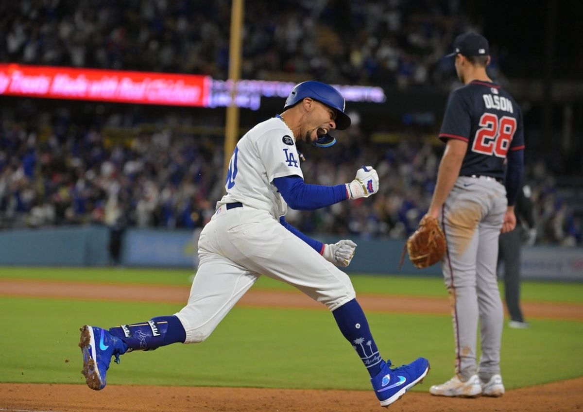 Apr 1, 2025; Los Angeles, California, USA;  Los Angeles Dodgers shortstop Mookie Betts (50) reacts after hitting a two run home run during the sixth inning against the Atlanta Braves at Dodger Stadium. Mandatory Credit: Jayne Kamin-Oncea-Imagn Images