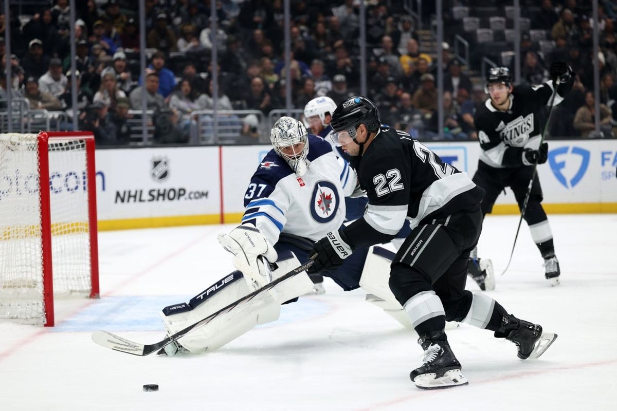 Apr 1, 2025; Los Angeles, California, USA;  Los Angeles Kings left wing Kevin Fiala (22) looks to shoot the puck against Winnipeg Jets goaltender Connor Hellebuyck (37) during the second period at Crypto.com Arena. Mandatory Credit: Kiyoshi Mio-Imagn Images