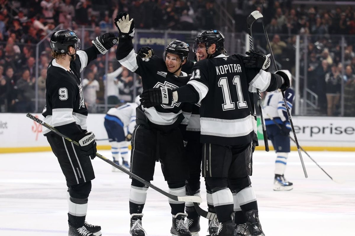 Apr 1, 2025; Los Angeles, California, USA;  Los Angeles Kings left wing Andrei Kuzmenko (96) celebrates with right wing Adrian Kempe (9) and center Anze Kopitar (11) after scoring a goal during the second period against the Winnipeg Jets at Crypto.com Arena. Mandatory Credit: Kiyoshi Mio-Imagn Images