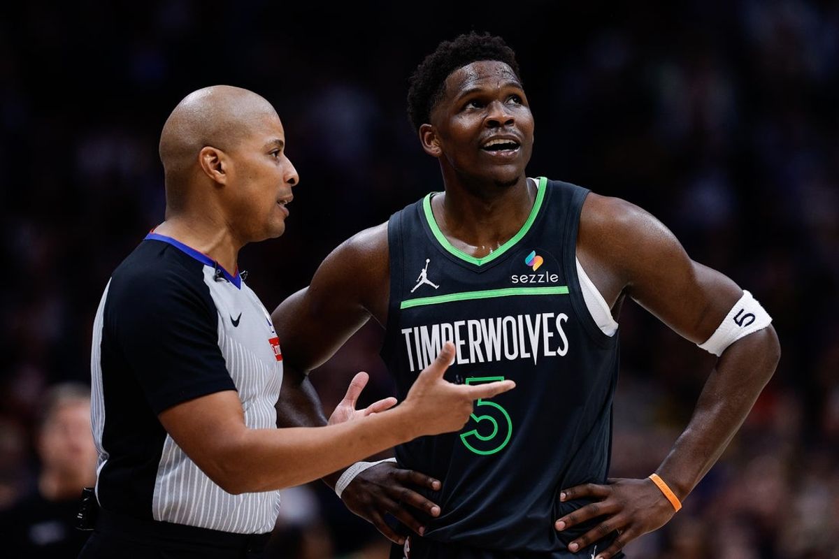 Apr 1, 2025; Denver, Colorado, USA; Minnesota Timberwolves guard Anthony Edwards (5) talks with referee CJ Washington (12) in overtime against the Denver Nuggets at Ball Arena. Mandatory Credit: Isaiah J. Downing-Imagn Images