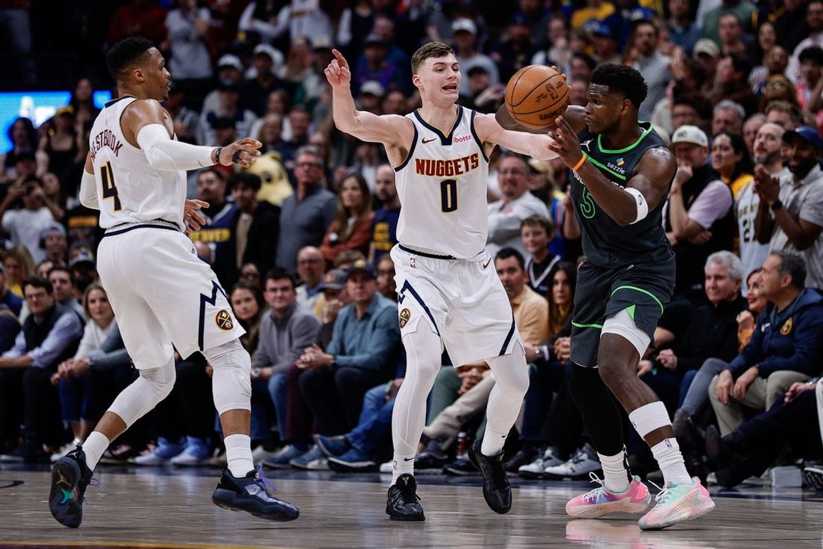 Apr 1, 2025; Denver, Colorado, USA; Minnesota Timberwolves guard Anthony Edwards (5) passes the ball under pressure from Denver Nuggets guard Christian Braun (0) and guard Russell Westbrook (4) in overtime at Ball Arena. Mandatory Credit: Isaiah J. Downing-Imagn Images