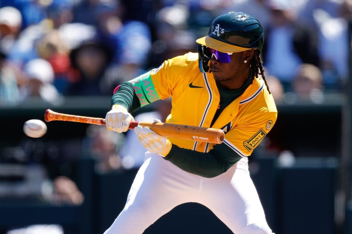Apr 2, 2025; West Sacramento, California, USA; Athletics outfielder Lawrence Butler (4) lays down a bunt during the third inning against the Chicago Cubs at Sutter Health Park. Mandatory Credit: Sergio Estrada-Imagn Images
