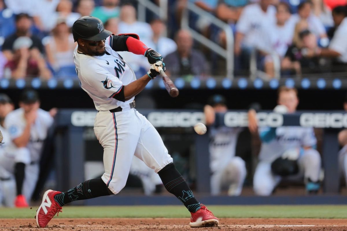 Apr 2, 2025; Miami, Florida, USA; Miami Marlins second baseman Otto Lopez (6) hits an RBI single against the New York Mets during the third inning at loanDepot Park. Mandatory Credit: Sam Navarro-Imagn Images