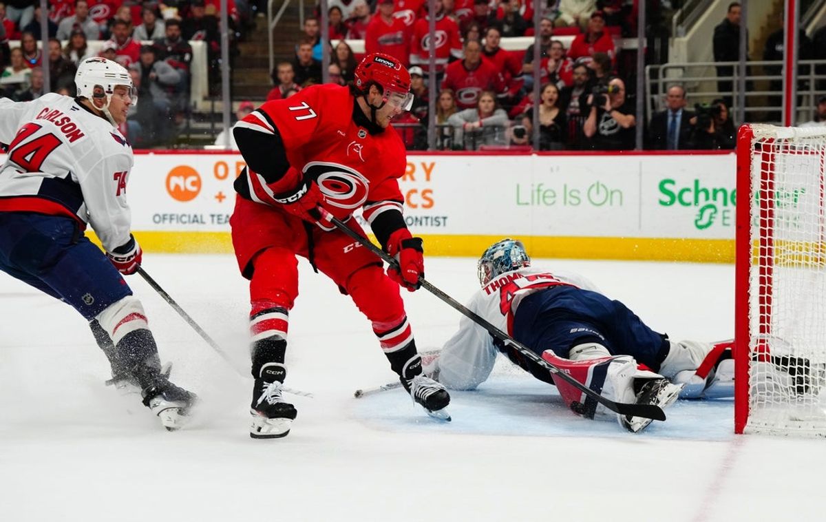 Apr 2, 2025; Raleigh, North Carolina, USA;  Washington Capitals goaltender Logan Thompson (48) stops a shot by Carolina Hurricanes center Mark Jankowski (77) during the first period at Lenovo Center. Mandatory Credit: James Guillory-Imagn Images