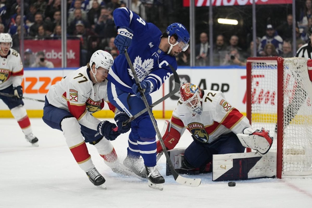 Apr 2, 2025; Toronto, Ontario, CAN; Toronto Maple Leafs forward Auston Matthews (34), Florida Panthers defenseman Niko Mikkola (77) and goaltender Sergei Bobrovsky (72) battle to get to a loose puck during the first period at Scotiabank Arena. Mandatory Credit: John E. Sokolowski-Imagn Images