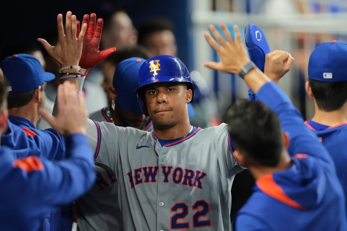 Apr 2, 2025; Miami, Florida, USA; New York Mets right fielder Juan Soto (22) celebrates with teammates after scoring against the Miami Marlins during the eleventh inning at loanDepot Park. Mandatory Credit: Sam Navarro-Imagn Images