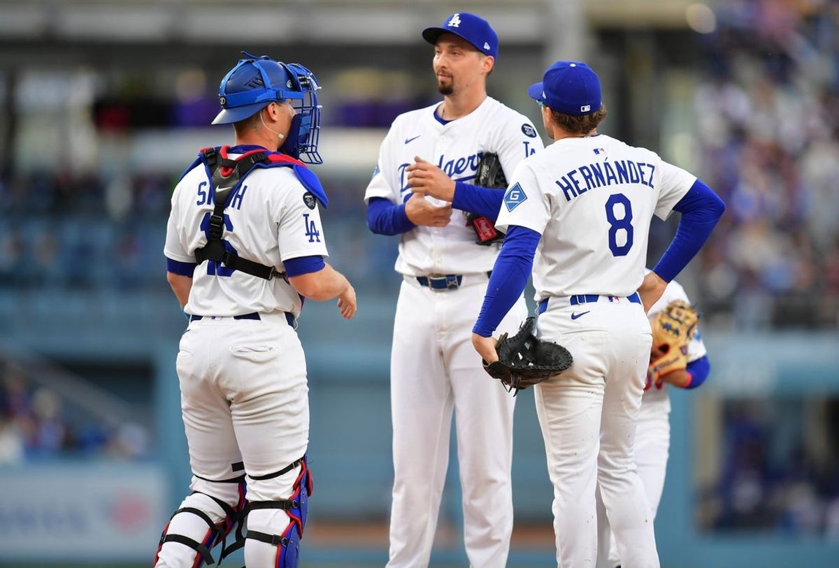 Apr 2, 2025; Los Angeles, California, USA; Los Angeles Dodgers pitcher Blake Snell (7) is visited by catcher Will Smith (16) and third baseman Enrique Hernandez (8) during the second inning against the Atlanta Braves at Dodger Stadium. Mandatory Credit: Gary A. Vasquez-Imagn Images