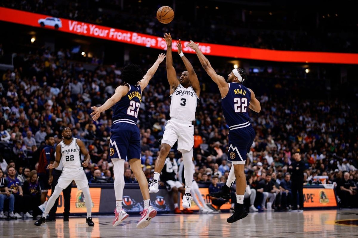 Apr 2, 2025; Denver, Colorado, USA; San Antonio Spurs guard Chris Paul (3) attempts a shot under pressure from Denver Nuggets guard Trey Alexander (23) and forward Zeke Nnaji (22) in the second quarter at Ball Arena. Mandatory Credit: Isaiah J. Downing-Imagn Images