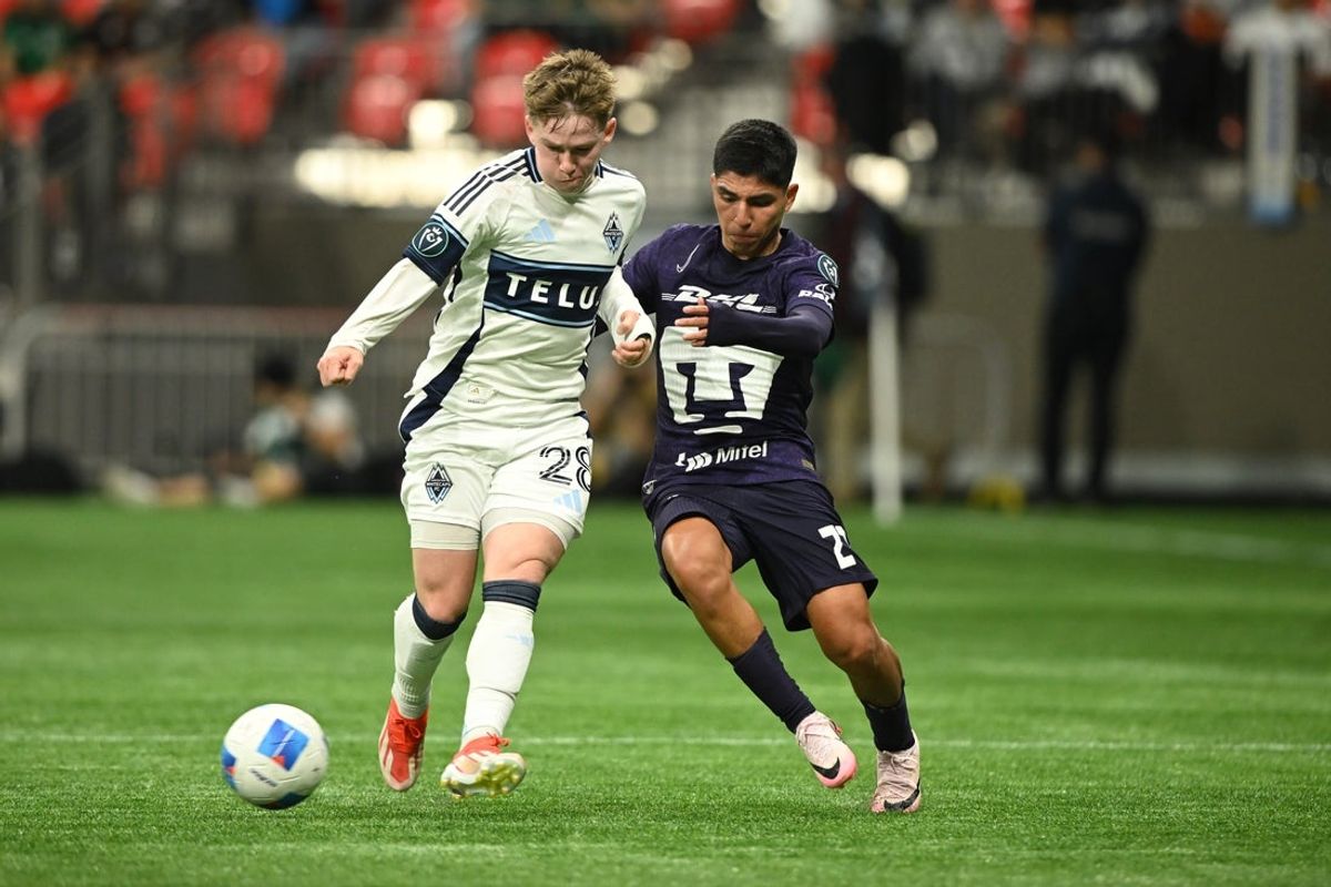 Apr 2, 2025; Vancouver, British Columbia, CAN;  Vancouver Whitecaps FC defender Tate Johnson (28) challenges Pumas UNAM defender Pablo Bennevendo (2) during the first half at BC Place. Mandatory Credit: Anne-Marie Sorvin-Imagn Images