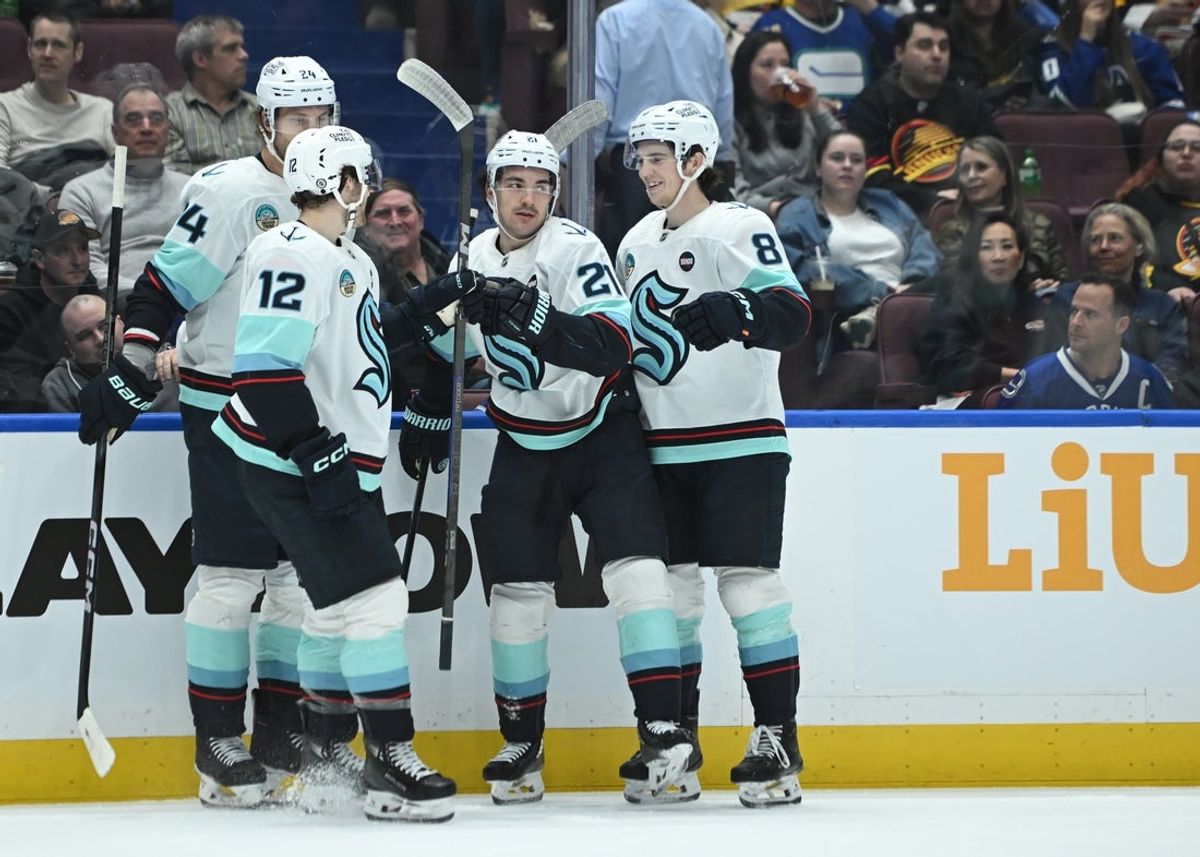 Apr 2, 2025; Vancouver, British Columbia, CAN; Seattle Kraken forward Michael Eyssimont (21) celebrates a goal with teammates against the Vancouver Canucks during the first period at Rogers Arena. Mandatory Credit: Simon Fearn-Imagn Images