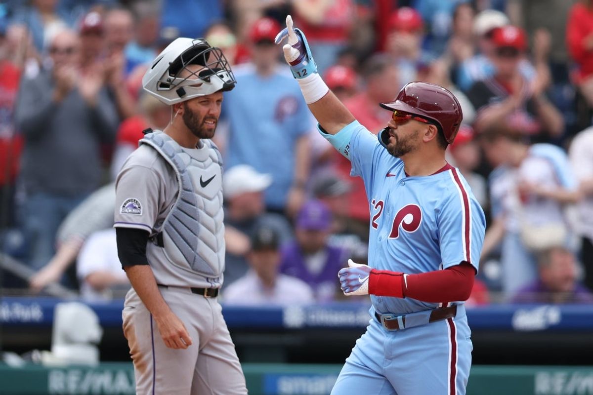 Apr 3, 2025; Philadelphia, Pennsylvania, USA; Philadelphia Phillies designated hitter Kyle Schwarber (12) reacts in front of Colorado Rockies catcher Jacob Stallings (25) after his home run during the seventh inning at Citizens Bank Park. Mandatory Credit: Bill Streicher-Imagn Images