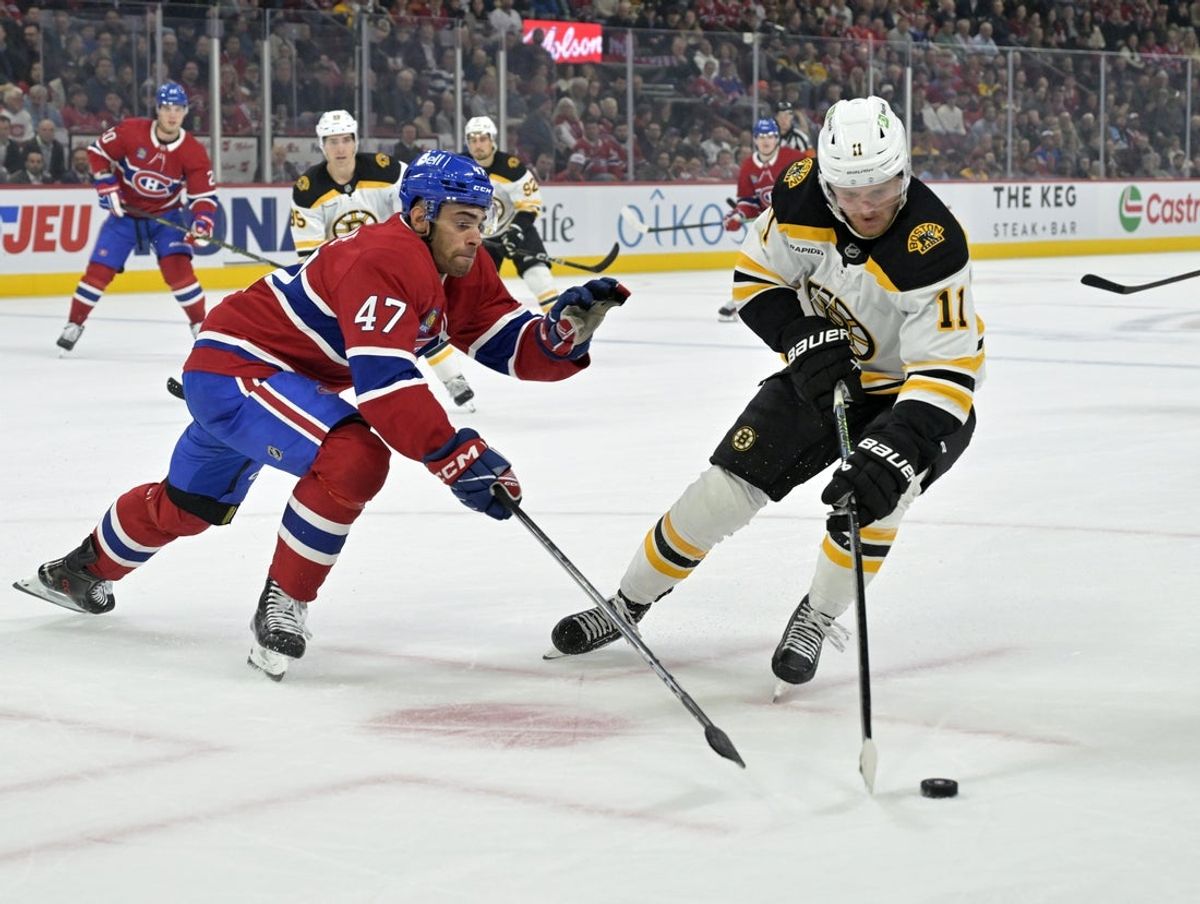 Apr 3, 2025; Montreal, Quebec, CAN; Boston Bruins forward Casey Mittelstadt (11) plays the puck and Montreal Canadiens defenseman Jayden Struble (47) defends during the first period at the Bell Centre. Mandatory Credit: Eric Bolte-Imagn Images