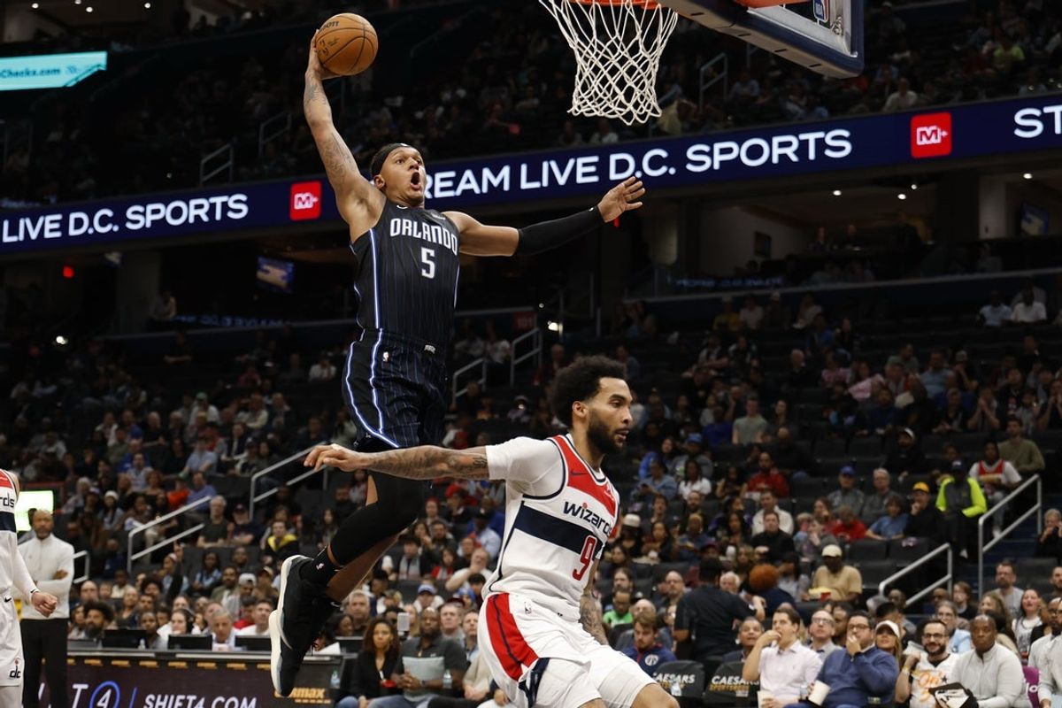 Apr 3, 2025; Washington, District of Columbia, USA; Orlando Magic forward Paolo Banchero (5) dunks the ball as Washington Wizards forward Justin Champagnie (9) defends in the first half at Capital One Arena. Mandatory Credit: Geoff Burke-Imagn Images