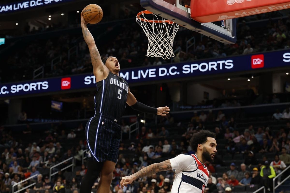 Apr 3, 2025; Washington, District of Columbia, USA; Orlando Magic forward Paolo Banchero (5) dunks the ball as Washington Wizards forward Justin Champagnie (9) defends in the first half at Capital One Arena. Mandatory Credit: Geoff Burke-Imagn Images